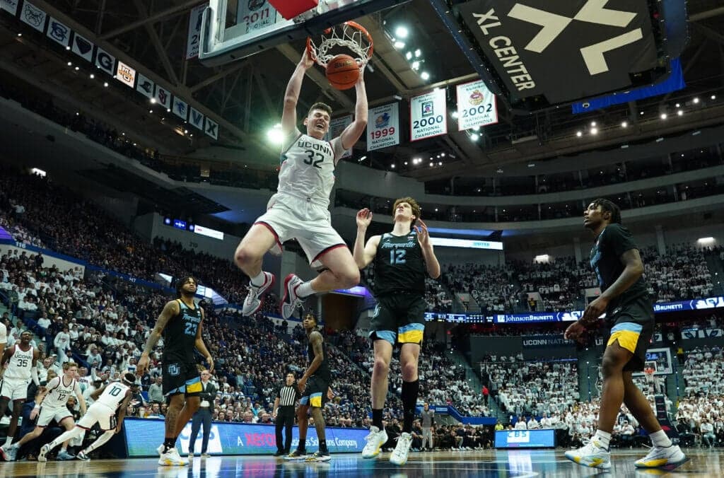 Feb 17, 2024; Hartford, Connecticut, USA; UConn Huskies center Donovan Clingan (32) makes the basket against the Marquette Golden Eagles in the second half at XL Center. Mandatory Credit: David Butler II-USA TODAY Sports